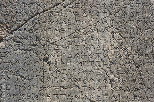 Macro view of script on Inscribed Pillar in Xanthos Ancient City photo