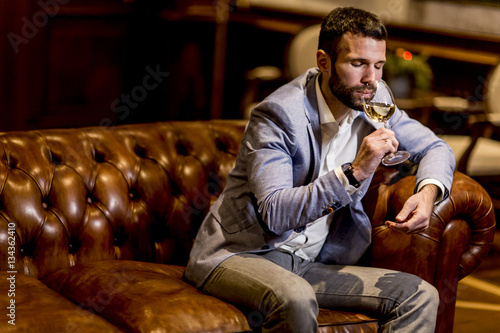 Young man tasting white wine