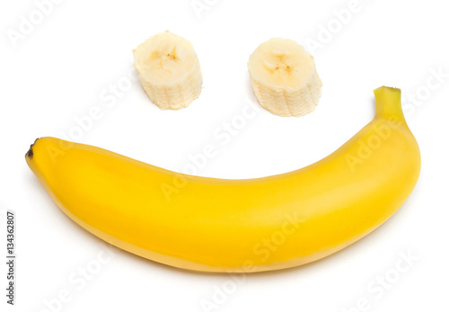 Banana clown with a slice isolated on white background. Flat lay