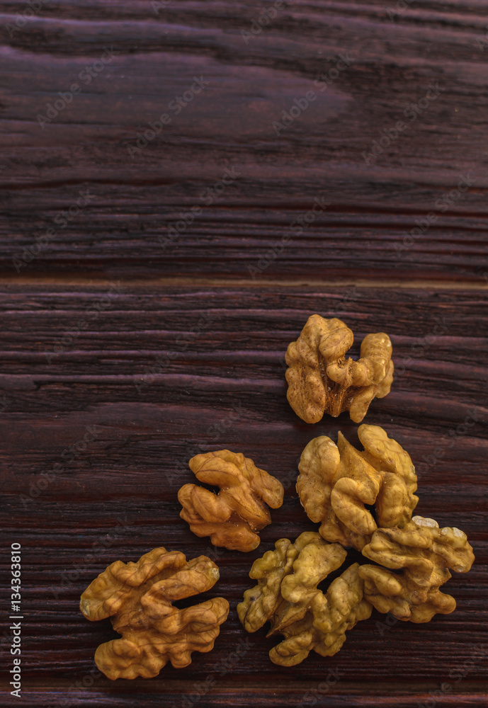 Walnut on the wooden table dark textural Walnut on the wooden table dark textural