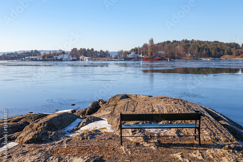 Photography Rocky shore with a bench to relax