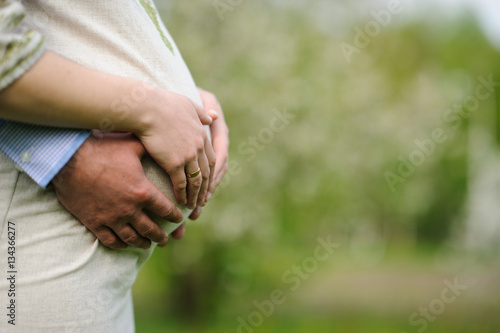 pregnant woman with husband  in blooming garden © Art_man