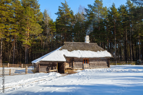 Traditional wooden cottage, baltic and scandinavian style. Winter scene in the countryside. © yegorov_nick