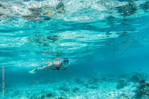 Woman snorkeling underwater in Indian Ocean  Maldives