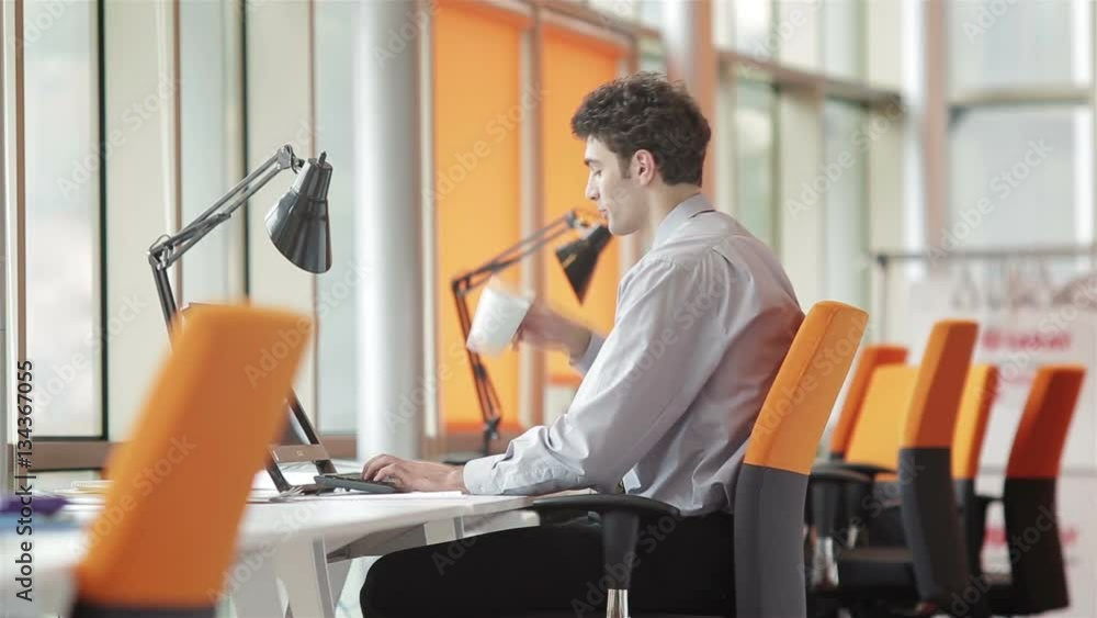 frustrated young business man working on laptop computer at office frustrated young business man working on laptop computer at office