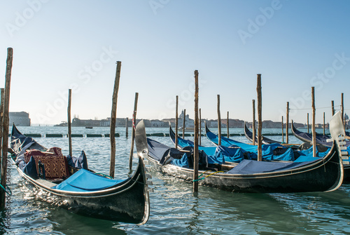 Gondolas near St. Mark's Square,Venice,Italy,20 January 2017,winter panorama gondolas in windy weather, the January,the first mention of a gondola in historical documents as early as the 10th century © Rita
