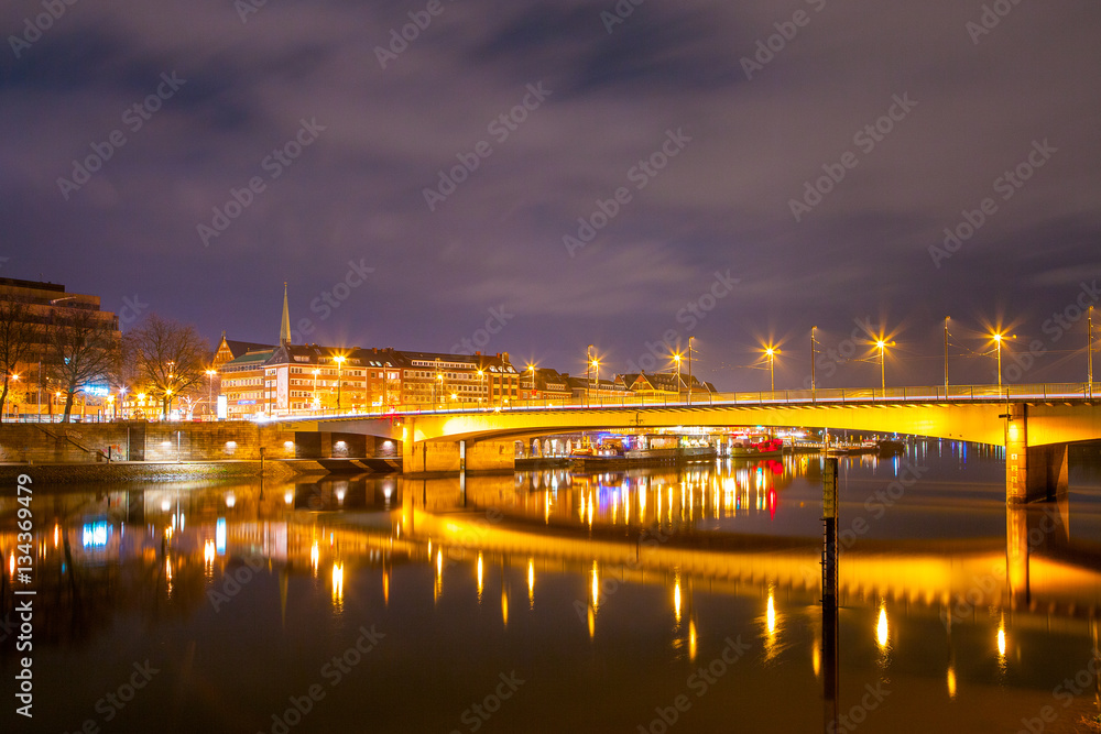 Fototapeta Cityscape of night Bremen, Germany over the Rhein river