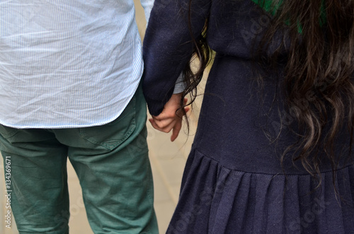 Lovebirds boy and a girl holding hands photo
