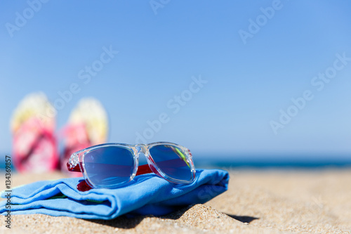 Seashore with sunglasses on plaid