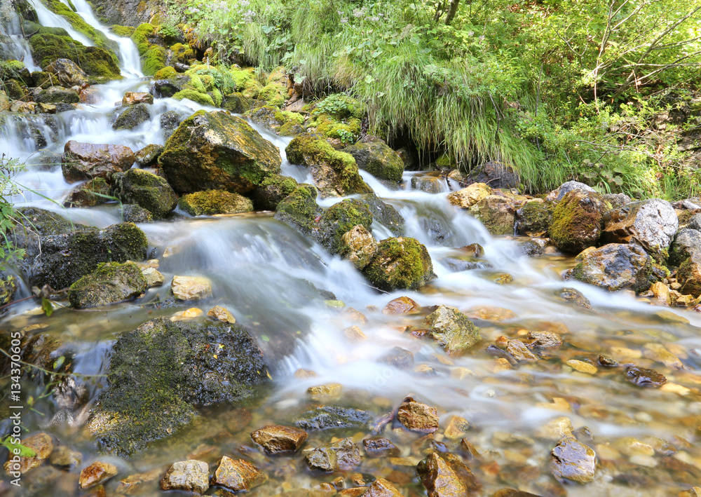 mountain stream with water that seems in motion photographed wit mountain stream with water that seems in motion photographed wit