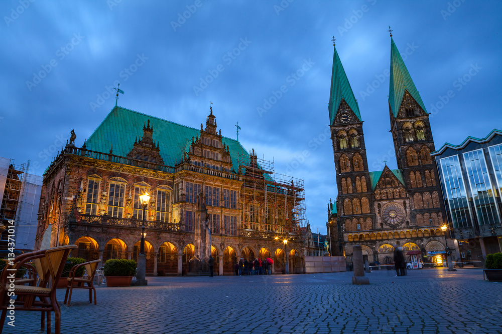 City hall and St. Peter Cathedral on the market square. Evening view with illumination.