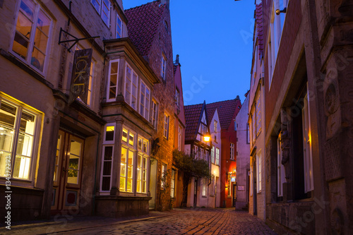 Historic streets of illuminated Schnoor quarter at night photo