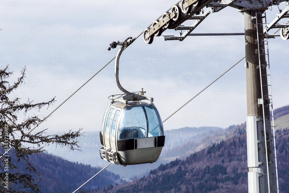 Ski lift cable booth or car, Ropeway and cableway transport system for skiers with fog on valley background. Ski lift cable booth or car, Ropeway and cableway transport system for skiers with fog on valley background.
