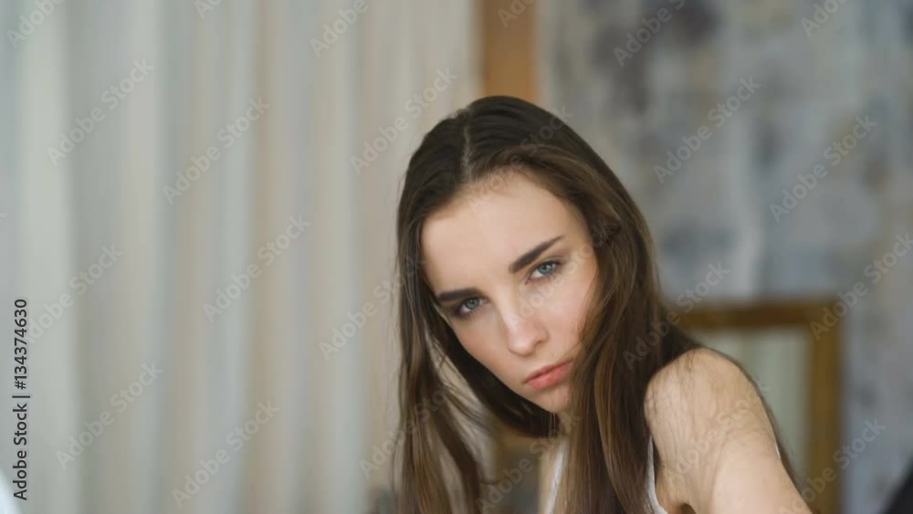 Professional fashion model posing and looking into camera. Woman show poses and emotions closeup Professional fashion model posing and looking into camera. Woman show poses and emotions closeup