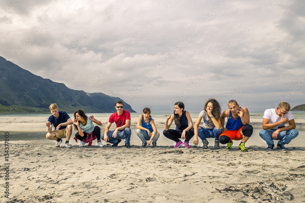 Group of young people enjoying the time at Norway's beach Group of young people enjoying the time at Norway's beach