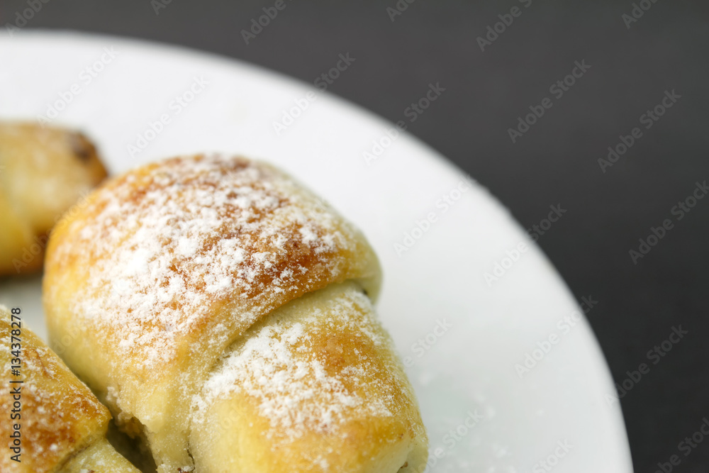 Homemade fresh bagels in white plate on dark gray background. Homemade fresh bagels in white plate on dark gray background.