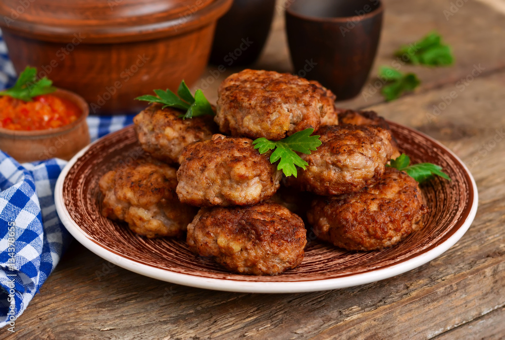 Homemade meatballs with meat and onions on a wooden background. Homemade meatballs with meat and onions on a wooden background.