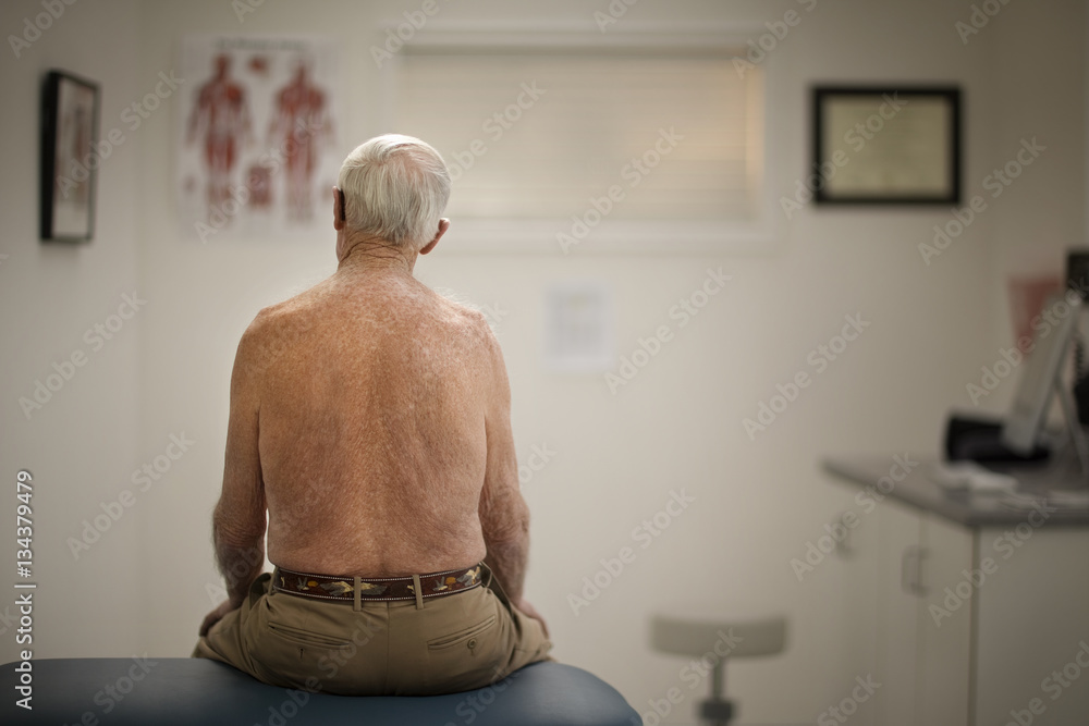 © Erickson Stock - Rear view of senior man sitting in clinic