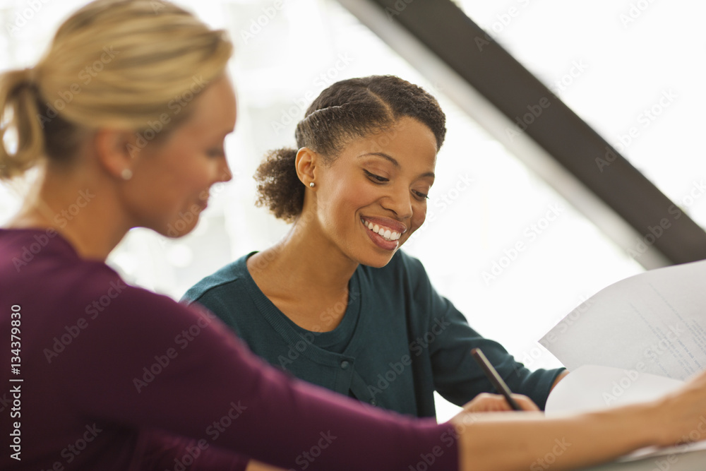 Happy colleagues working together on a project. Happy colleagues working together on a project.