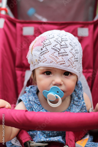 Close up portrait of little girl baby one years old. Baby with p