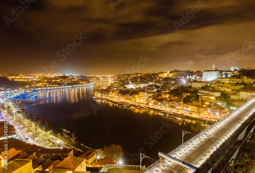 Dom Luis I bridge over Douro river illuminated at night, Porto, Portugal