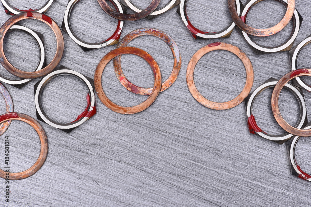 Nuts and Washers on Metal Background, Top View Nuts and Washers on Metal Background, Top View