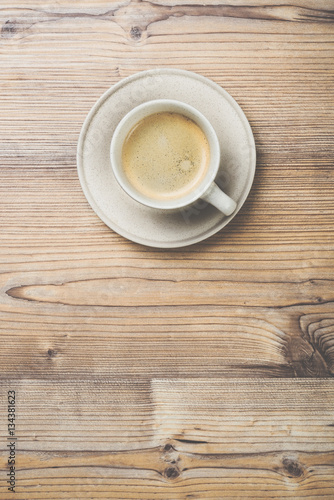 Cup of coffee on wooden vintage board background