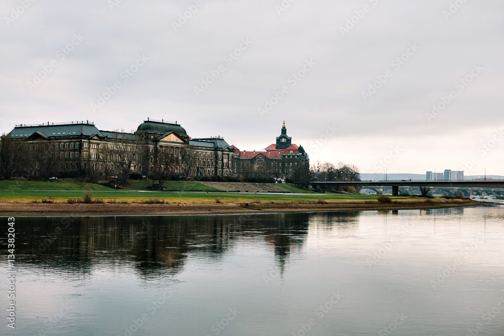 View of the River Elbe in Dresden, Germany. With reflections of houses in water.