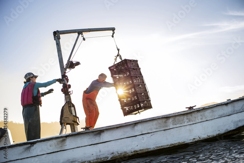 Family operating their fishing boat. photo