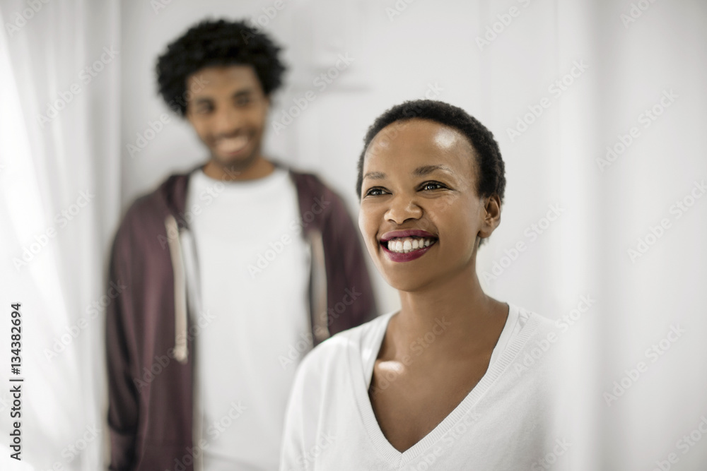 Portrait of a smiling couple inside their home.