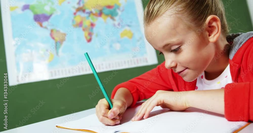 Slow motion of schoolgirl doing homework in classroom at school 4k Slow motion of schoolgirl doing homework in classroom at school 4k