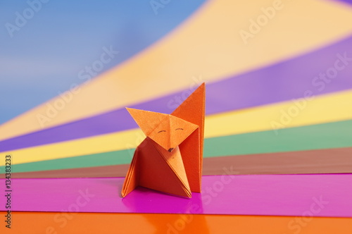 
Paper origami fox isolated on a colorful background