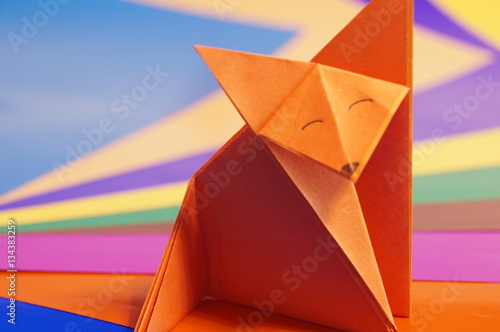  Paper origami fox isolated on a colorful background