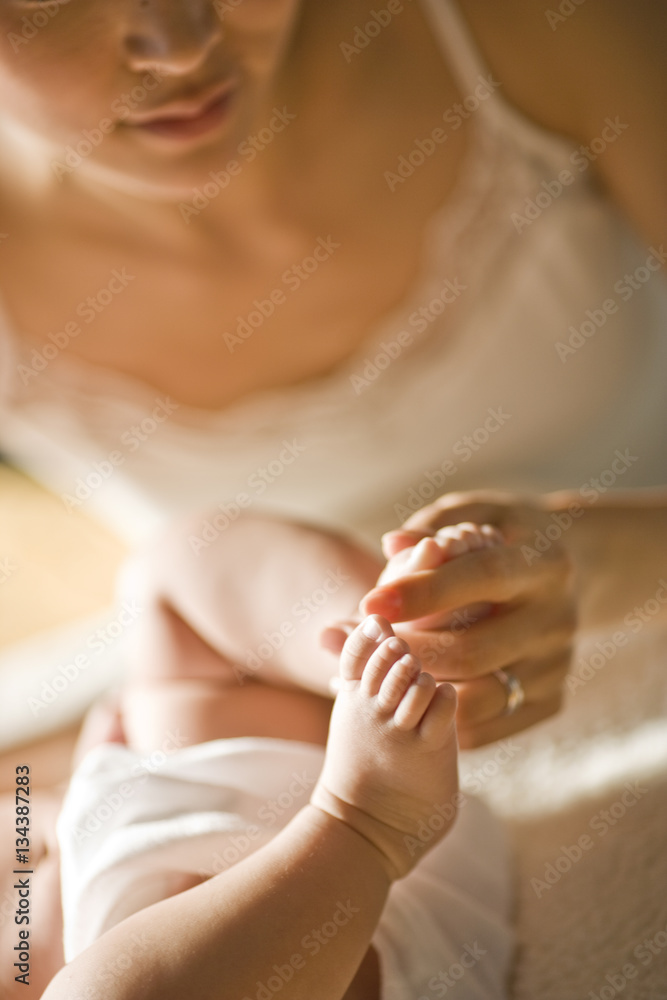 Baby's feet being held by it's mother. Baby's feet being held by it's mother.