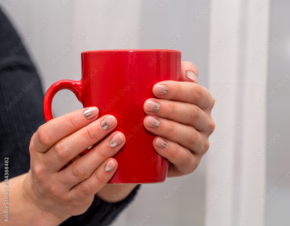 female hands holding a red Cup, close-up female hands holding a red Cup, close-up