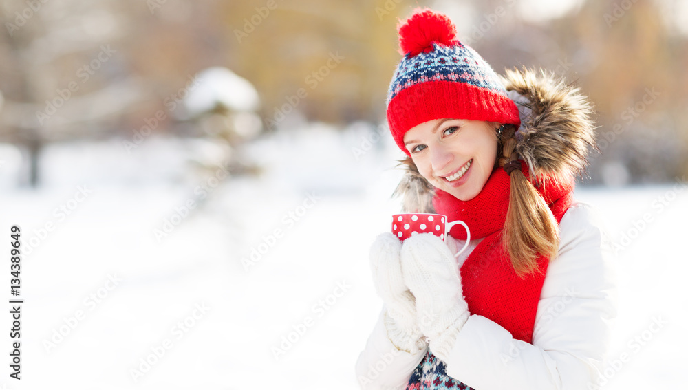 happy young woman drinking tea in winter