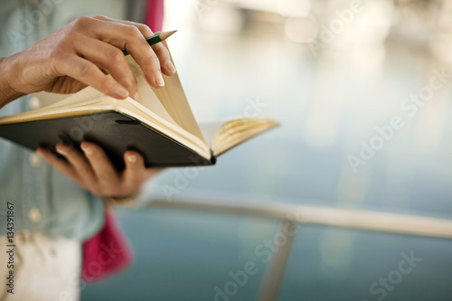 Woman flicks through a diary.
