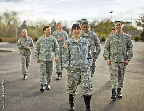 Group of US smiling army soldiers walking outdoors