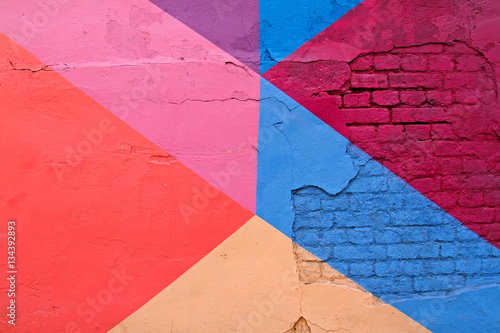 Colorful brick wall with purple, blue, pink, and beige as background texture