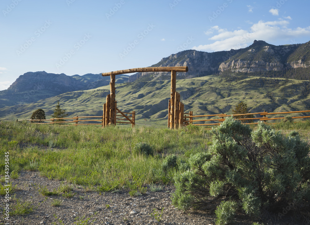 Ranch gate below Absaroka mountains in Wyoming
