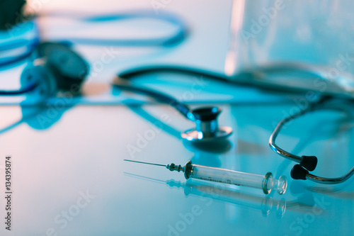 Syringe and Medical Blood Pressure device on blue