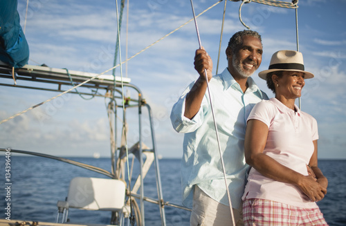 Mature couple enjoying view of water from boat deck.