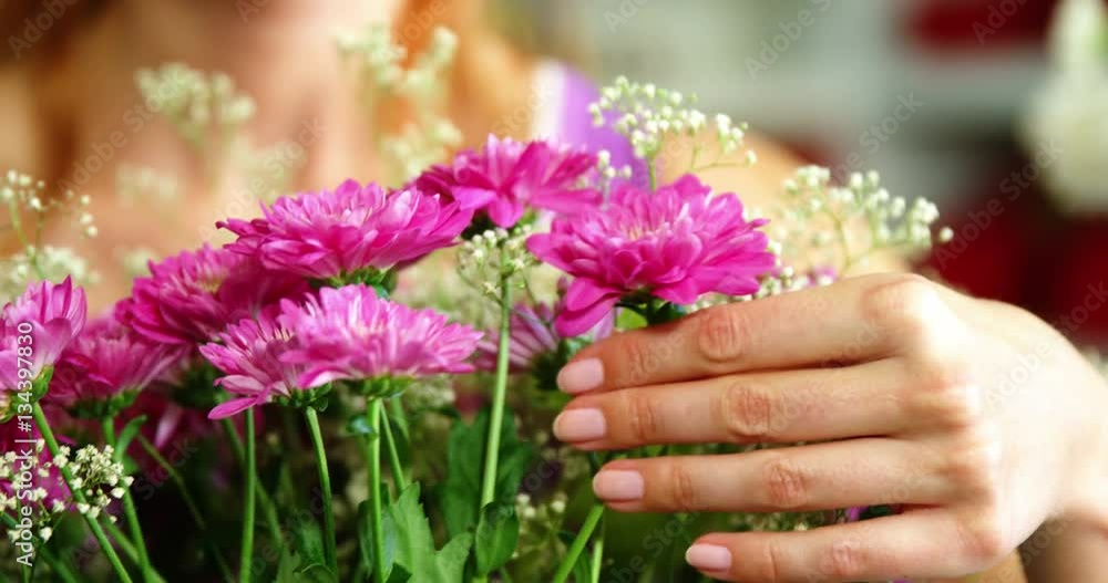 Close-up of female florist arraigning flower bouquet in flower shop Close-up of female florist arraigning flower bouquet in flower shop