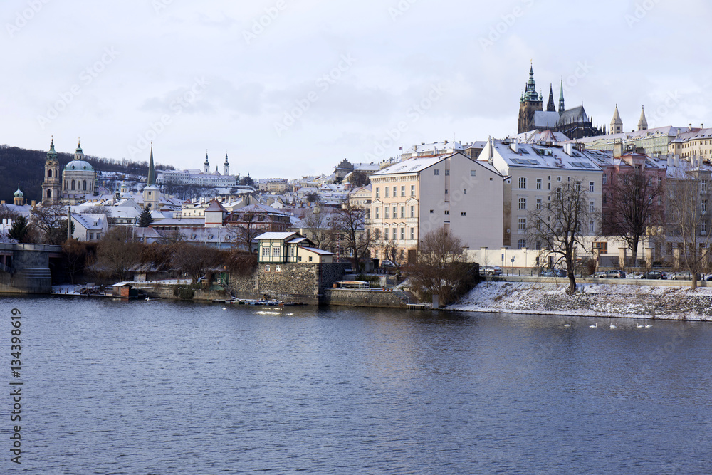 Snowy freeze Prague Lesser Town with gothic Castle above River Vltava, Czech republic