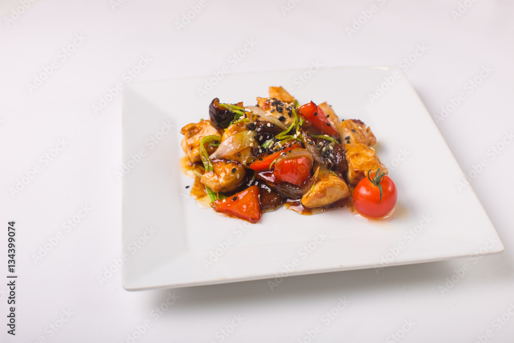 Teriyaki chicken with cherry tomatoes on a white background Teriyaki chicken with cherry tomatoes on a white background