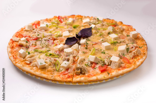 Pizza with cheese, tomatoes and chicken on a white background