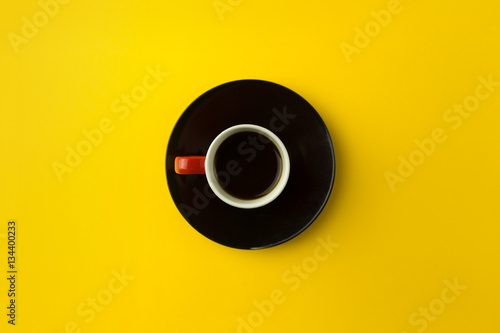 Coffee cup on bright yellow background