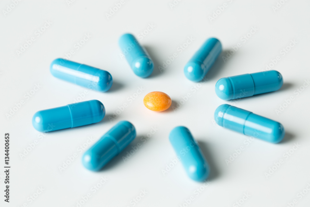 Blue medical pills and capsules pattern on white background. flat lay, top view. Blue medical pills and capsules pattern on white background. flat lay, top view.