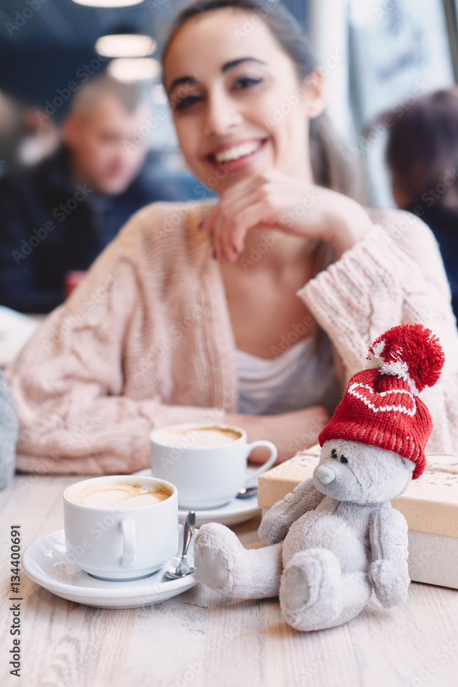 Teddy bear in a red cap on the table given Valentine's Day Teddy bear in a red cap on the table given Valentine's Day