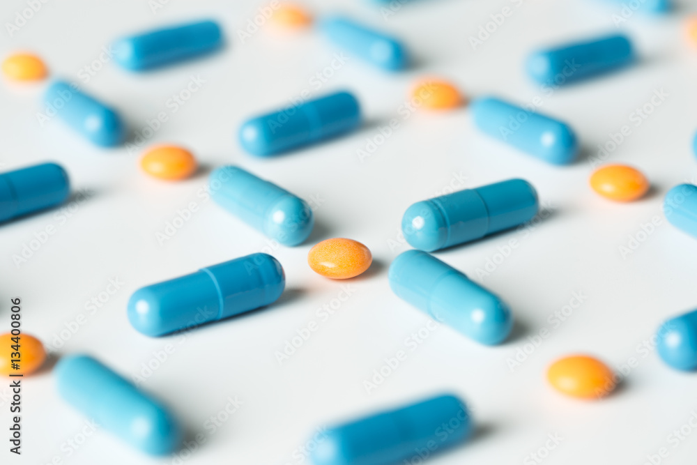 Blue medical pills and capsules pattern on white background. flat lay, top view. Blue medical pills and capsules pattern on white background. flat lay, top view.